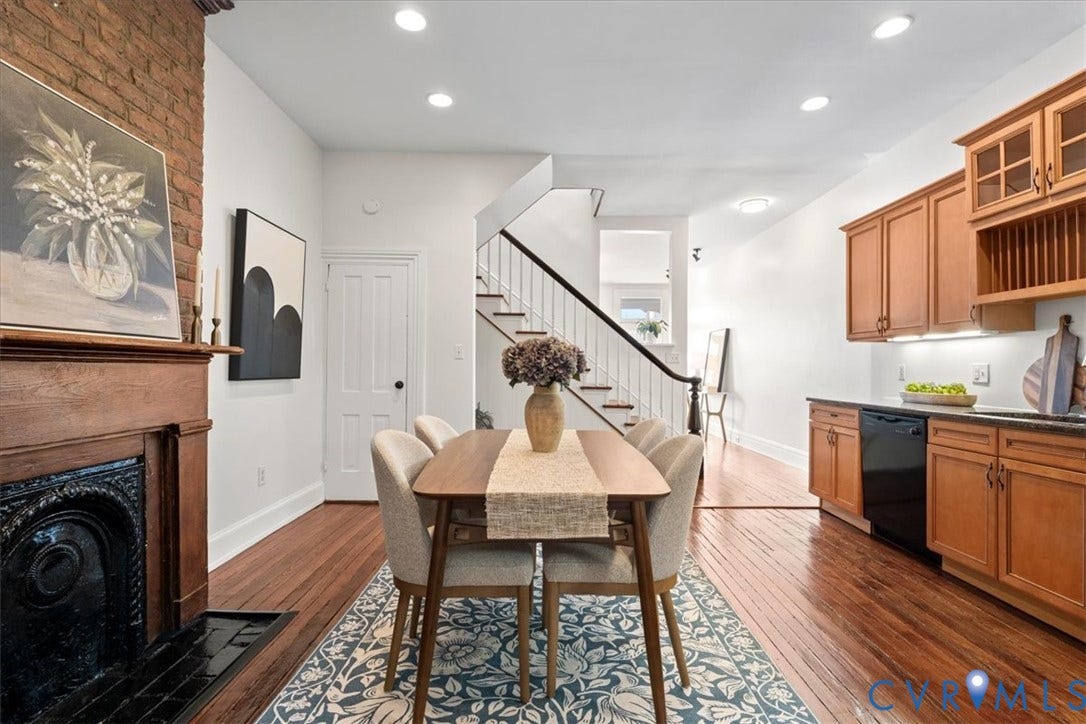 2510 E Leigh Street, Church Hill, Richmond, VA 23223 Hardwood flooring throughout, exposed brick accent wall, wood-mantel fireplace with cast iron insert, wood cabinetry with under-cabinet lighting, and recessed ceiling lighting
