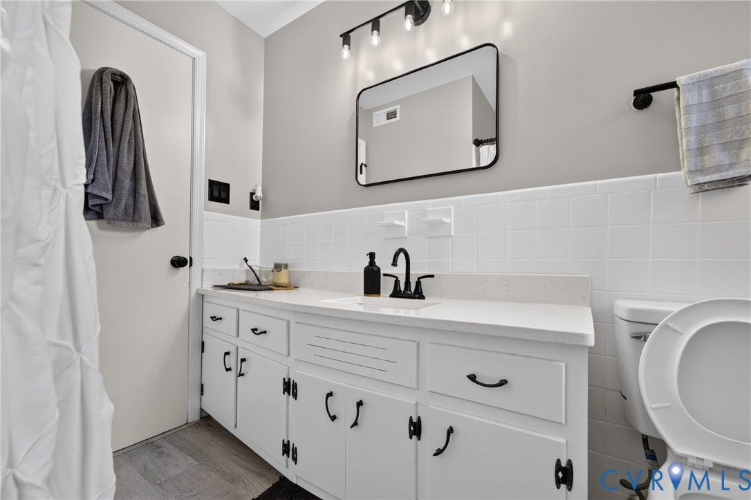 3401 Austin Avenue, Brentwood, Henrico, VA 23222 White vanity with black hardware, white countertop, and a black faucet