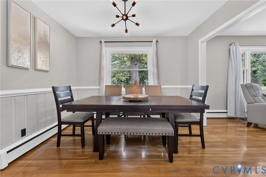 3401 Austin Avenue, Brentwood, Henrico, VA 23222 Dining area featuring a modern chandelier, wood-finish flooring, white trim details, and a large window
