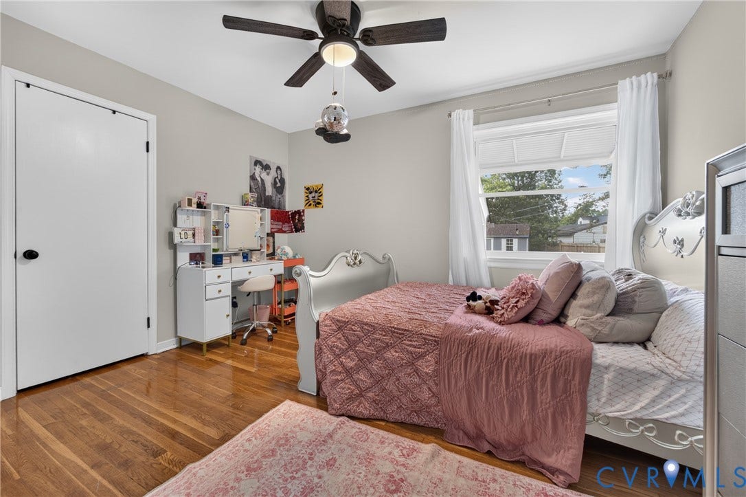 3401 Austin Avenue, Brentwood, Henrico, VA 23222 Room featuring wood-finish flooring, a ceiling fan with integrated lighting, a window with white trim, and a white interior door