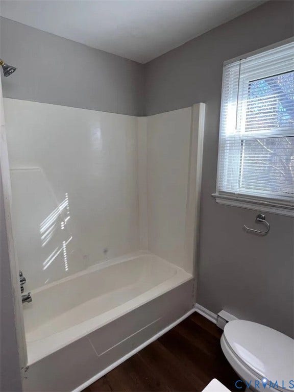 20507 Hickory Court, South Chesterfield, VA 23803 Modern bathroom featuring a white acrylic tub/shower combination with frameless glass enclosure, ceramic tile surround, and chrome fixtures