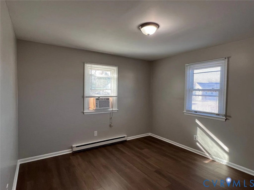20507 Hickory Court, South Chesterfield, VA 23803 Bright, airy bedroom featuring hardwood flooring, two large windows with natural light, ceiling-mounted light fixture, and fresh neutral wall finishes