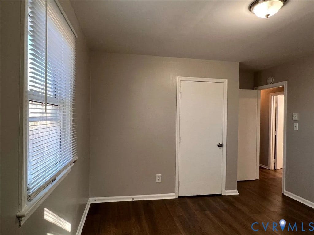 20507 Hickory Court, South Chesterfield, VA 23803 Bright and spacious room featuring hardwood flooring, neutral wall finishes, and abundant natural light from large windows with plantation shutters