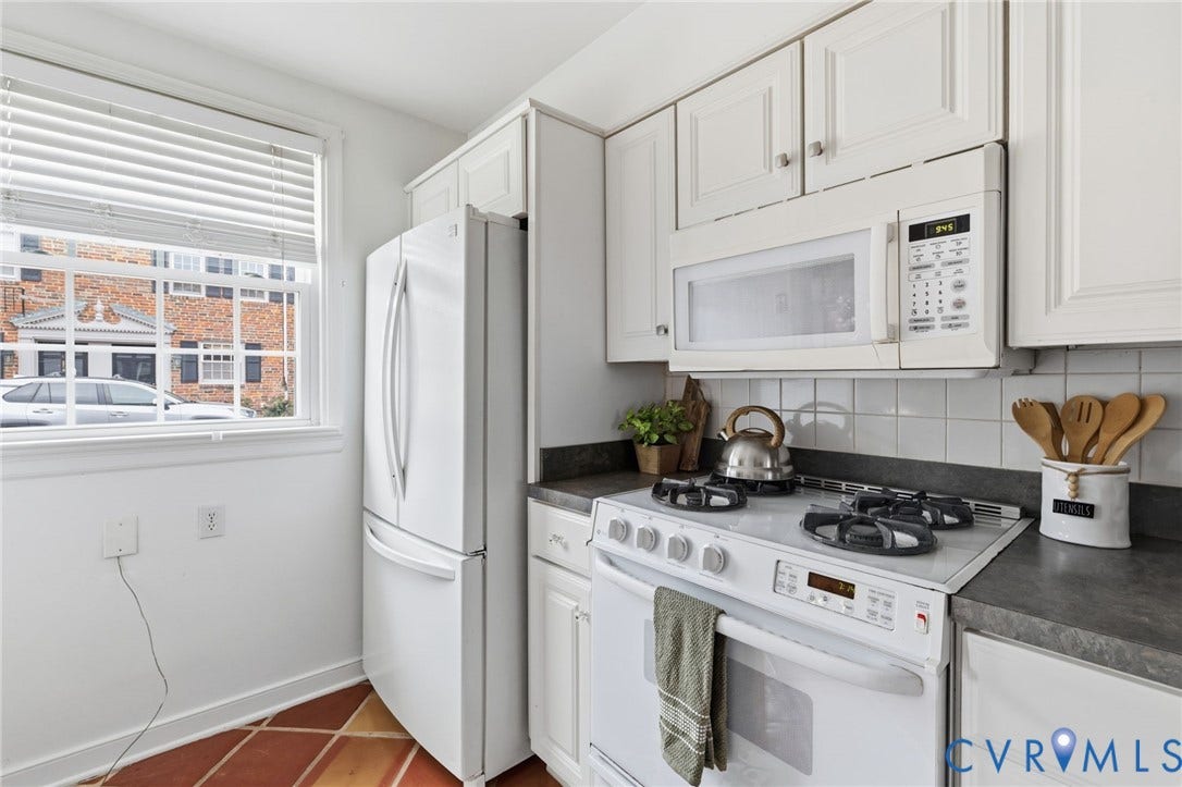 405 N Hamilton Street, #G, Richmond, VA 23221 White kitchen cabinetry, white appliances, dark countertops, and a white subway tile backsplash