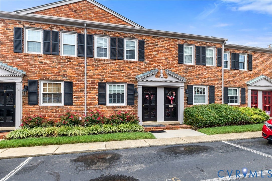 405 N Hamilton Street, #G, Richmond, VA 23221 Charming brick townhome featuring a classic front facade with black shutters, multiple windows providing natural light, and a covered entrance with pediment detailing