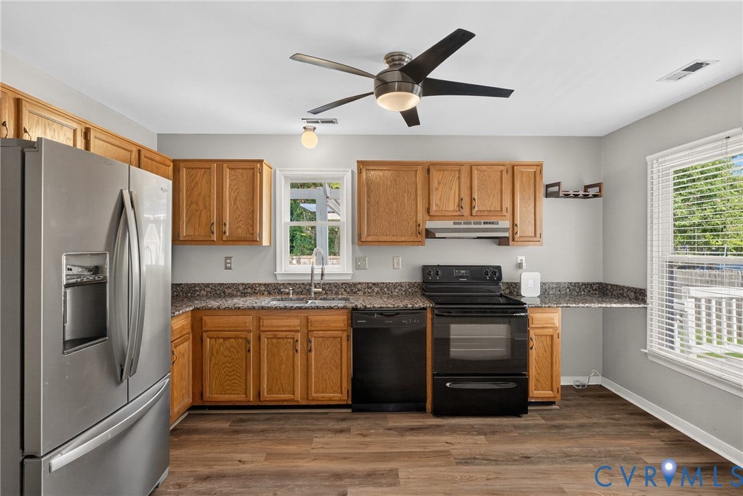 2020 Knotty Drive, Glen Allen, VA 23060 Well-appointed kitchen featuring wood cabinetry, granite countertops, stainless steel appliances including a double-wall oven, and a ceiling fan with integrated lighting