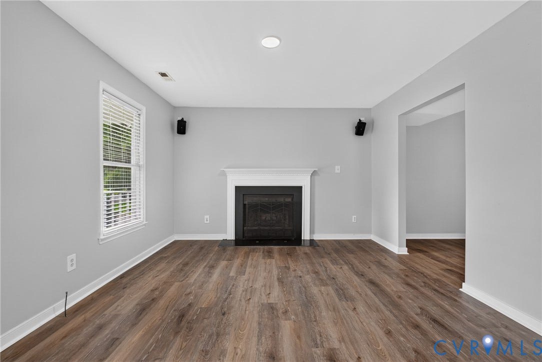 2020 Knotty Drive, Glen Allen, VA 23060 Wood-finish flooring, white trim, recessed lighting, white window blinds, and a black fireplace with white mantel