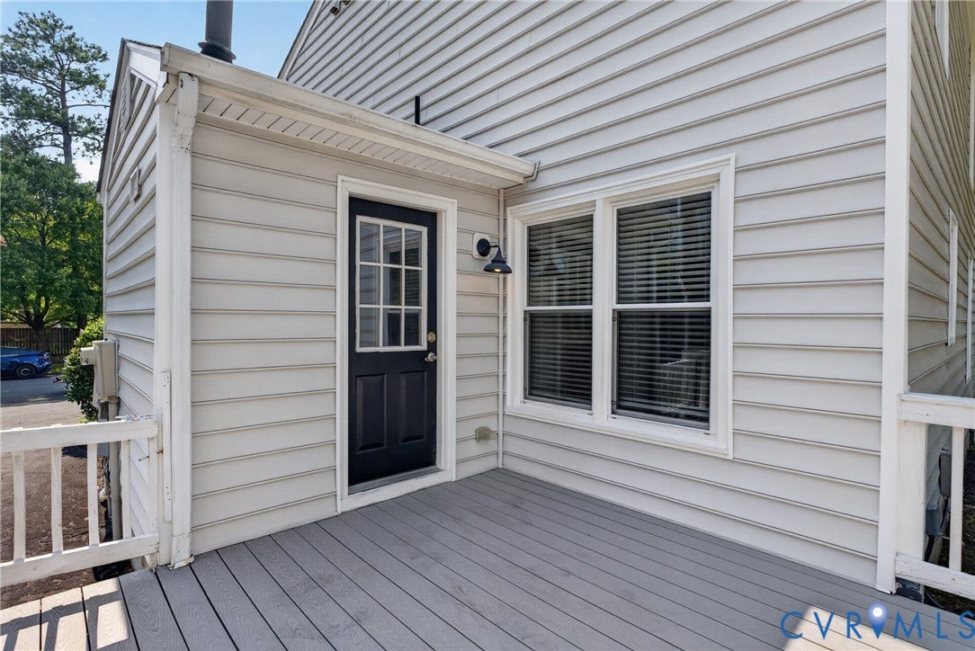 2020 Knotty Drive, Glen Allen, VA 23060 Composite deck with composite decking and white railings, anchoring a covered entry with black door and sidelights