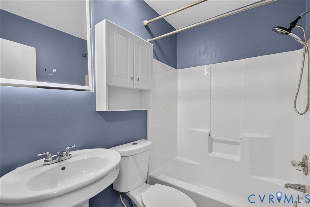2020 Knotty Drive, Glen Allen, VA 23060 Pedestal sink, wall-mounted cabinet, shower/tub combination, and a modern mirror with integrated lighting
