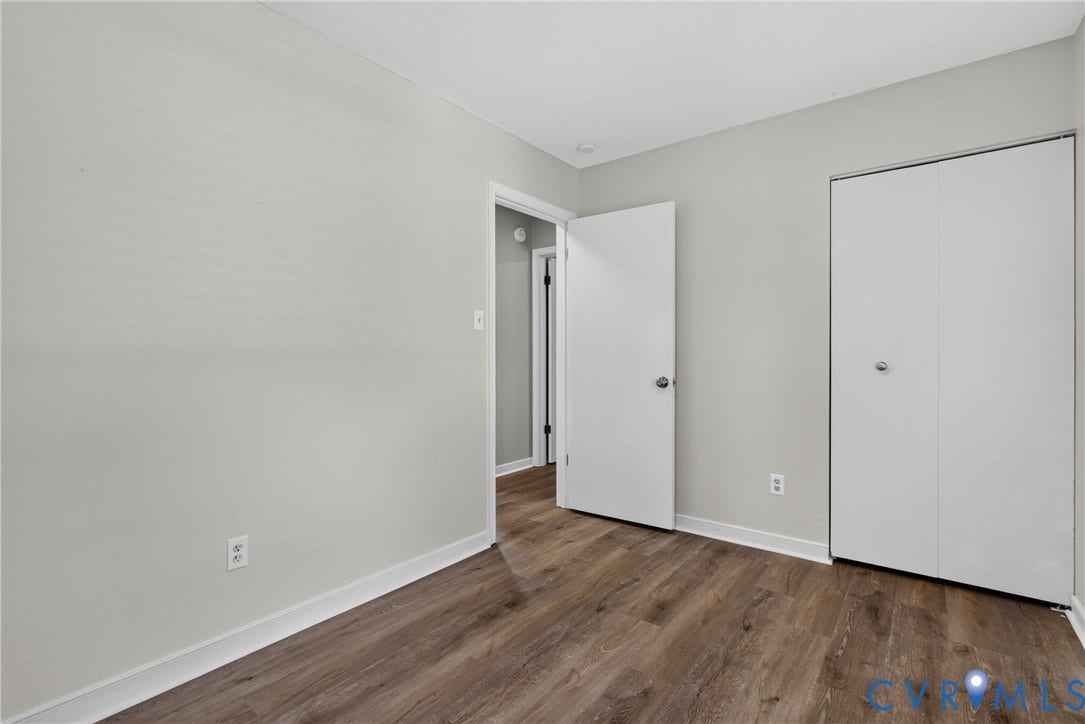2020 Knotty Drive, Glen Allen, VA 23060 Bright, neutral bedroom featuring wood-finish flooring, multiple closet spaces with white panel doors, and clean white walls with recessed lighting throughout