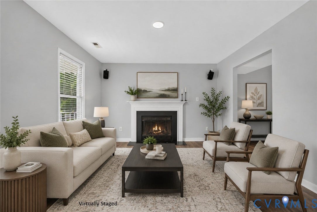 2020 Knotty Drive, Glen Allen, VA 23060 Elegant living room anchored by a gas fireplace with dark surround, complemented by recessed ceiling lighting and black wall-mounted sconces