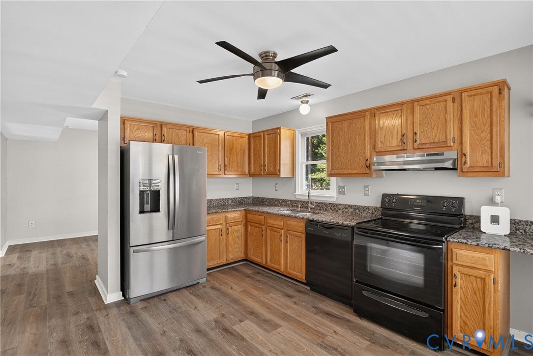 2020 Knotty Drive, Glen Allen, VA 23060 Updated kitchen featuring warm wood cabinetry, granite countertops, stainless steel appliances including a French-door refrigerator and gas range, black electric oven, and a ceiling fan