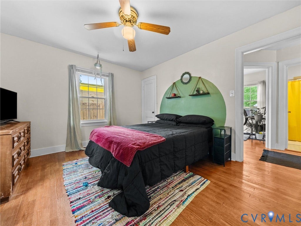 5023 E Seminary Avenue, Richmond, VA 23227 Bedroom featuring wood-finish flooring, a ceiling fan with integrated lighting, and a window with white trim