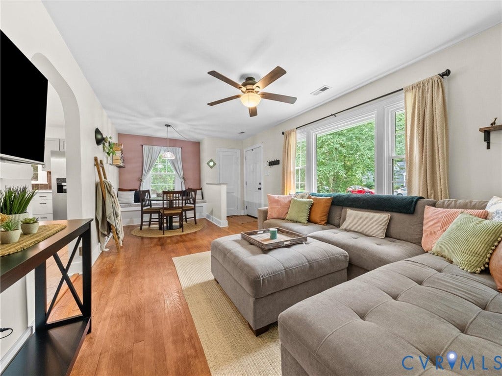 5023 E Seminary Avenue, Richmond, VA 23227 Living area featuring wood-finish flooring, a ceiling fan with integrated lighting, and a large window with white trim