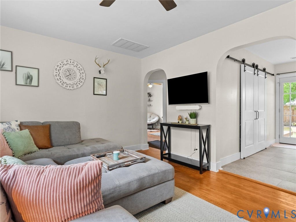 5023 E Seminary Avenue, Richmond, VA 23227 Living area featuring wood-finish flooring, light-toned walls, and an arched entryway