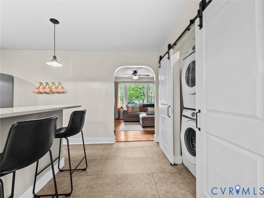 5023 E Seminary Avenue, Richmond, VA 23227 Kitchen bar seating with a light-toned countertop, pendant lighting, and tile flooring