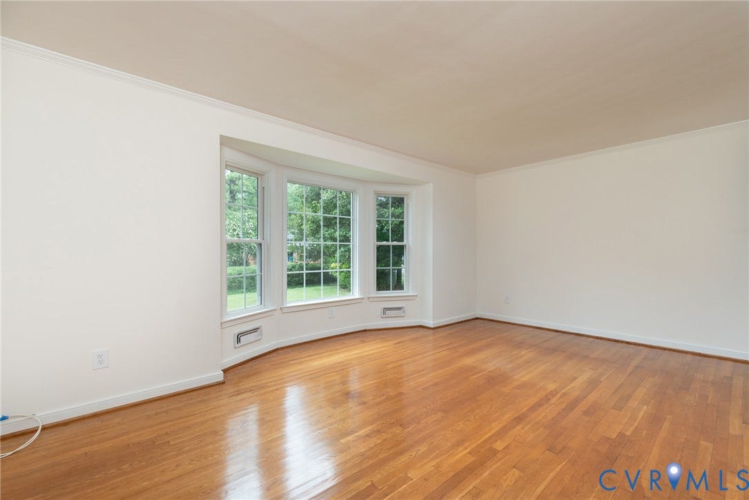 2519 Woodmont Drive, Woodmont, Chesterfield, VA 23235 Bay window with multiple panes, hardwood flooring, white walls, white crown molding, and white baseboards