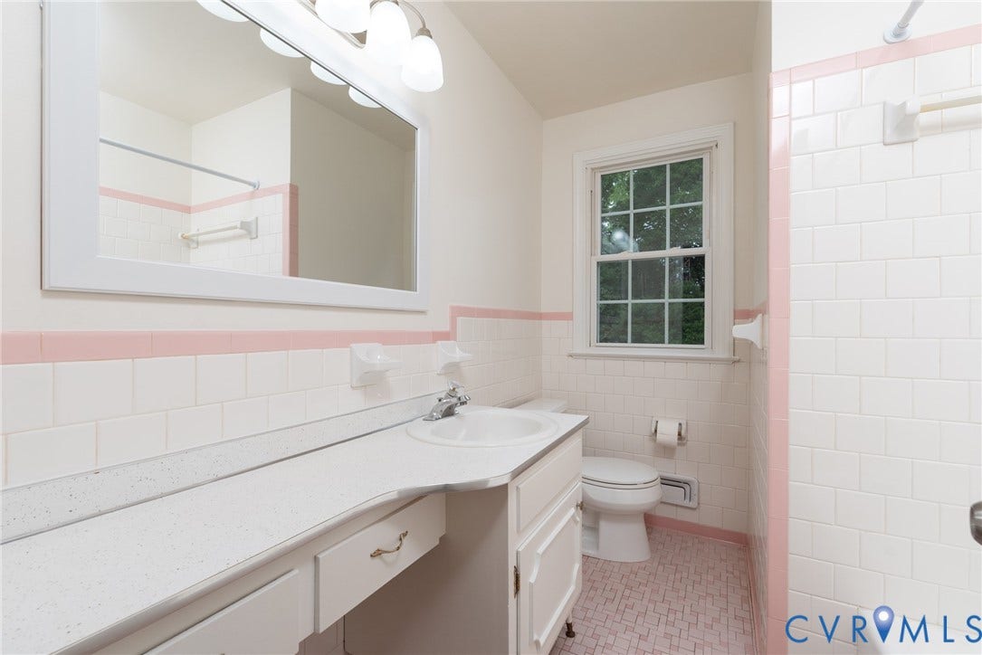 2519 Woodmont Drive, Woodmont, Chesterfield, VA 23235 Bathroom featuring a single vanity with an integrated sink, a rectangular mirror, and a three-light vanity fixture