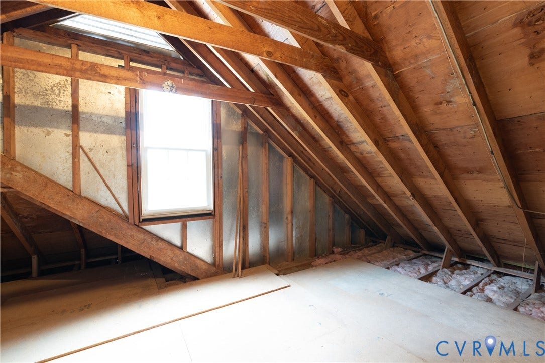 2519 Woodmont Drive, Woodmont, Chesterfield, VA 23235 Open attic space with exposed wood framing, a single window, and a skylight