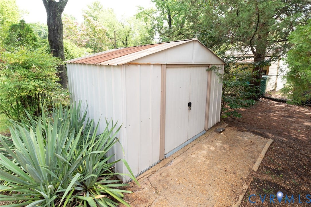 2519 Woodmont Drive, Woodmont, Chesterfield, VA 23235 Exterior storage shed with a peaked metal roof and double panel doors, set on a concrete slab