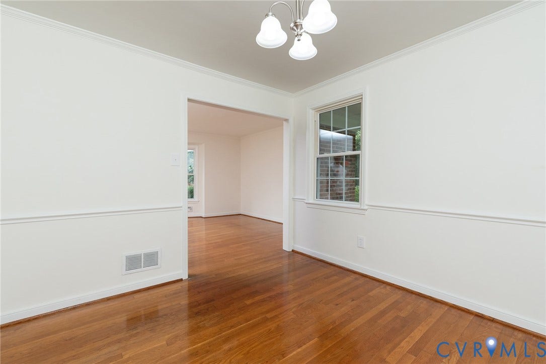 2519 Woodmont Drive, Woodmont, Chesterfield, VA 23235 Bright interior space featuring wood-finish flooring, white walls, and a decorative ceiling light fixture