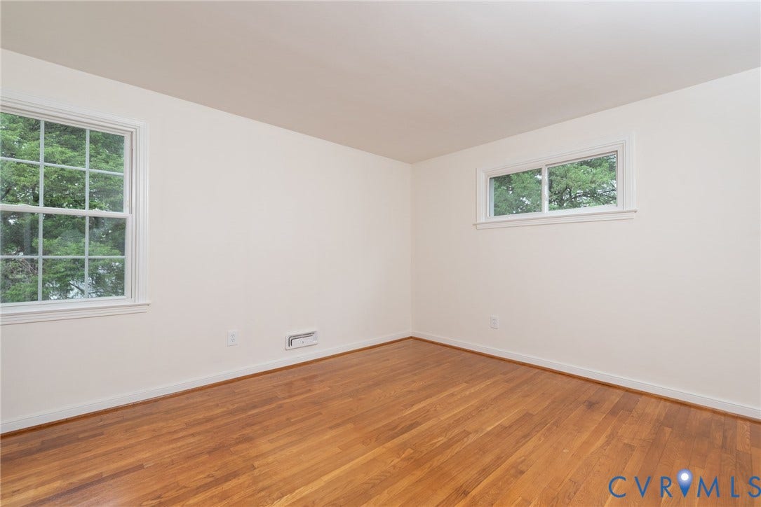 2519 Woodmont Drive, Woodmont, Chesterfield, VA 23235 Room featuring hardwood flooring, white baseboards, and two windows with white trim