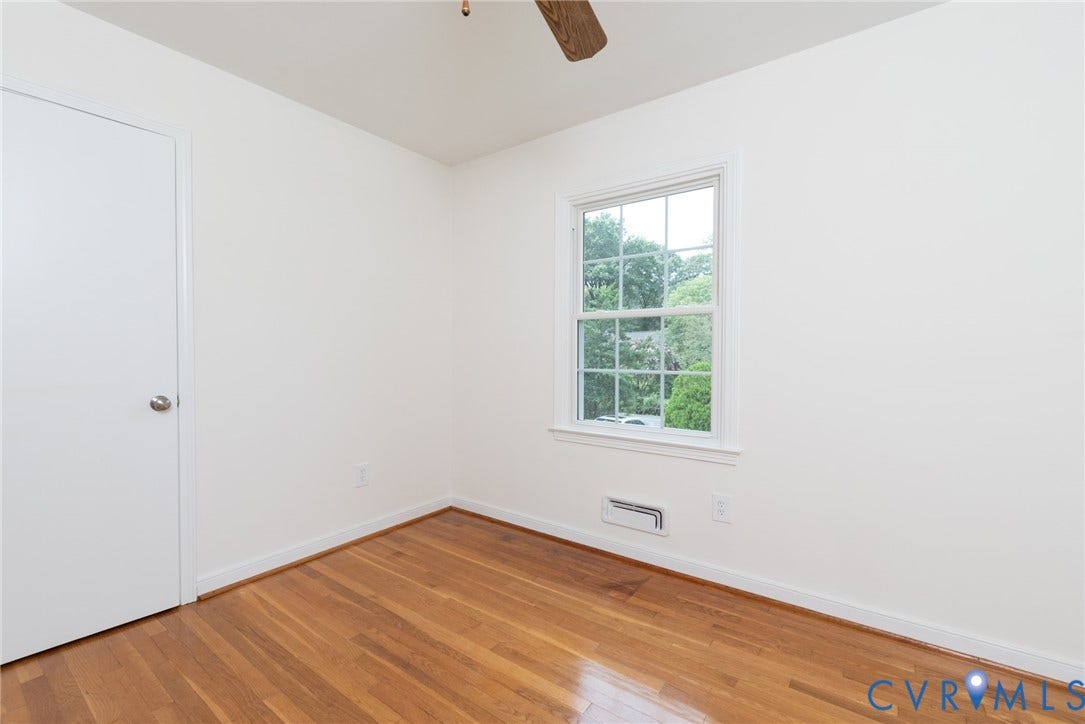 2519 Woodmont Drive, Woodmont, Chesterfield, VA 23235 Bedroom featuring hardwood flooring, white walls, and a multi-pane window with exterior tree views