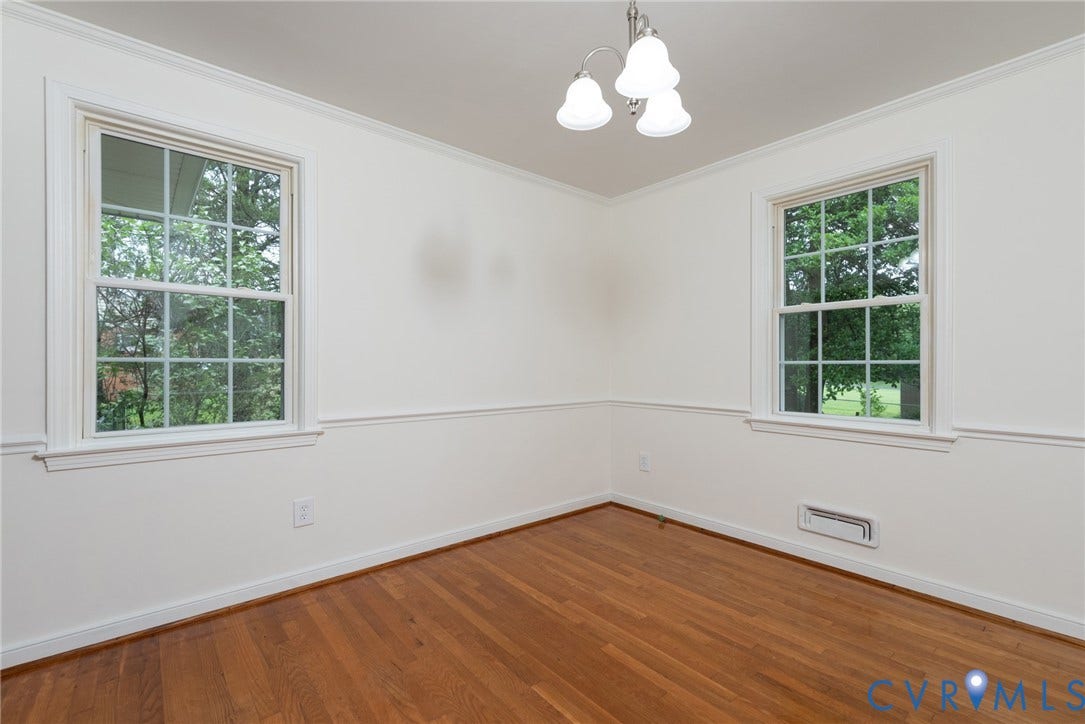 2519 Woodmont Drive, Woodmont, Chesterfield, VA 23235 Room featuring wood-finish flooring, two large windows with grid muntins, crown molding, chair rail molding, and a three-light ceiling fixture