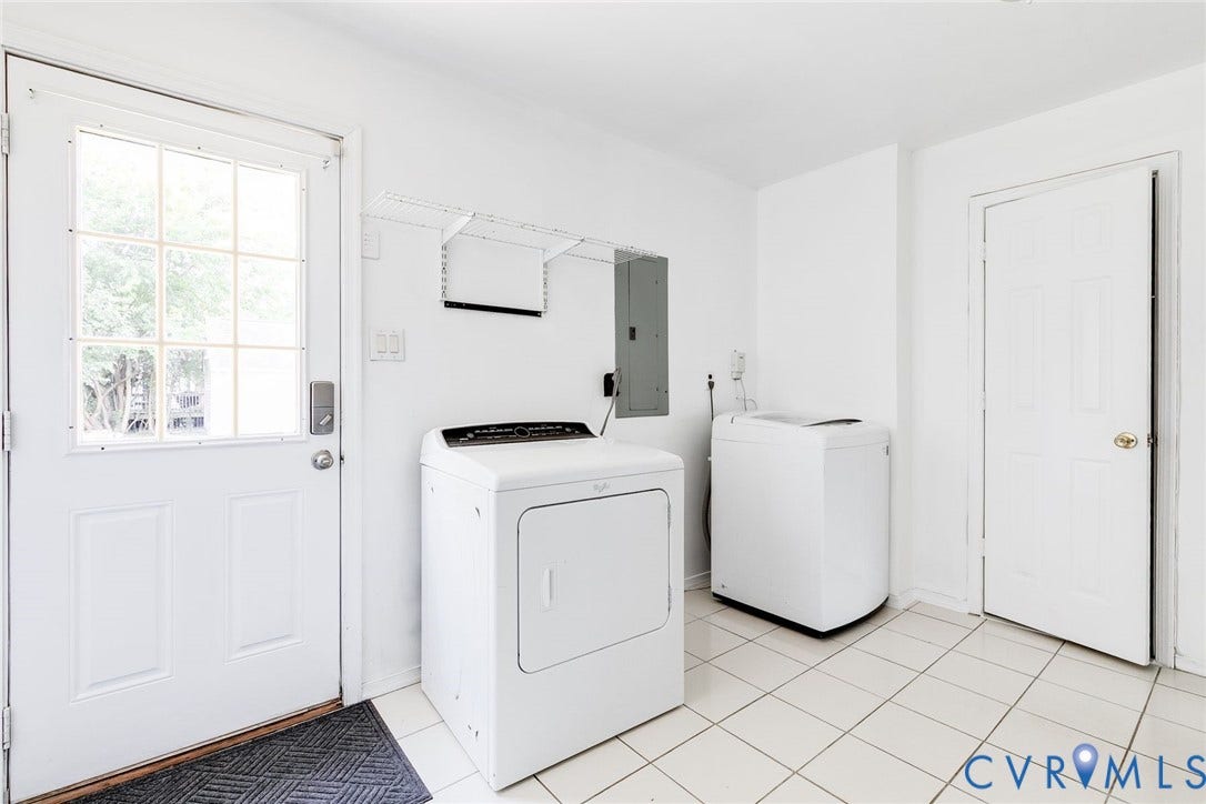 Laundry with full bathroom and direct access to the back yard.