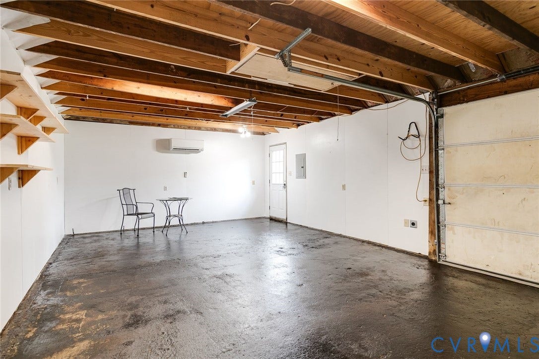 This garage is a DREAM for the craftsperson/mechanic/woodworker with a 100 -amp panel, brand new mini split and epoxy floor.