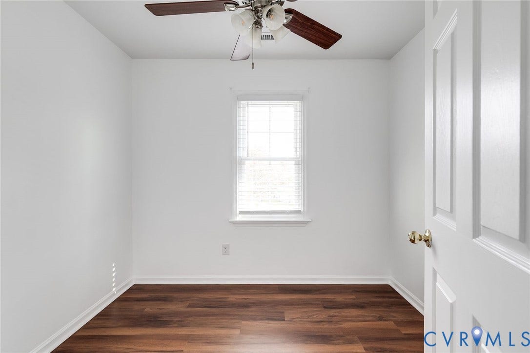 Bedroom 3 with fresh paint, new LVP flooring and ceiling fan.