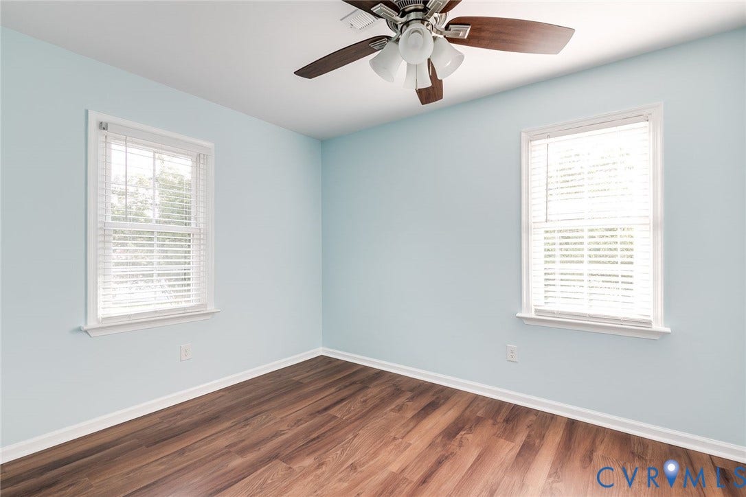 Bedroom 2 with fresh paint, new LVP flooring and ceiling fan.