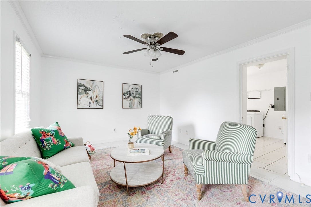 The ground level family room is freshly painted with excellent natural light and ceiling fan.