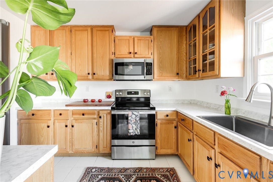 Joyful kitchen with stainless appliances, ample counter space and maple cabinetry with sleek hardware.