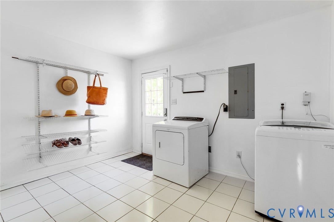 Tiled laundry room with direct access to the driveway.