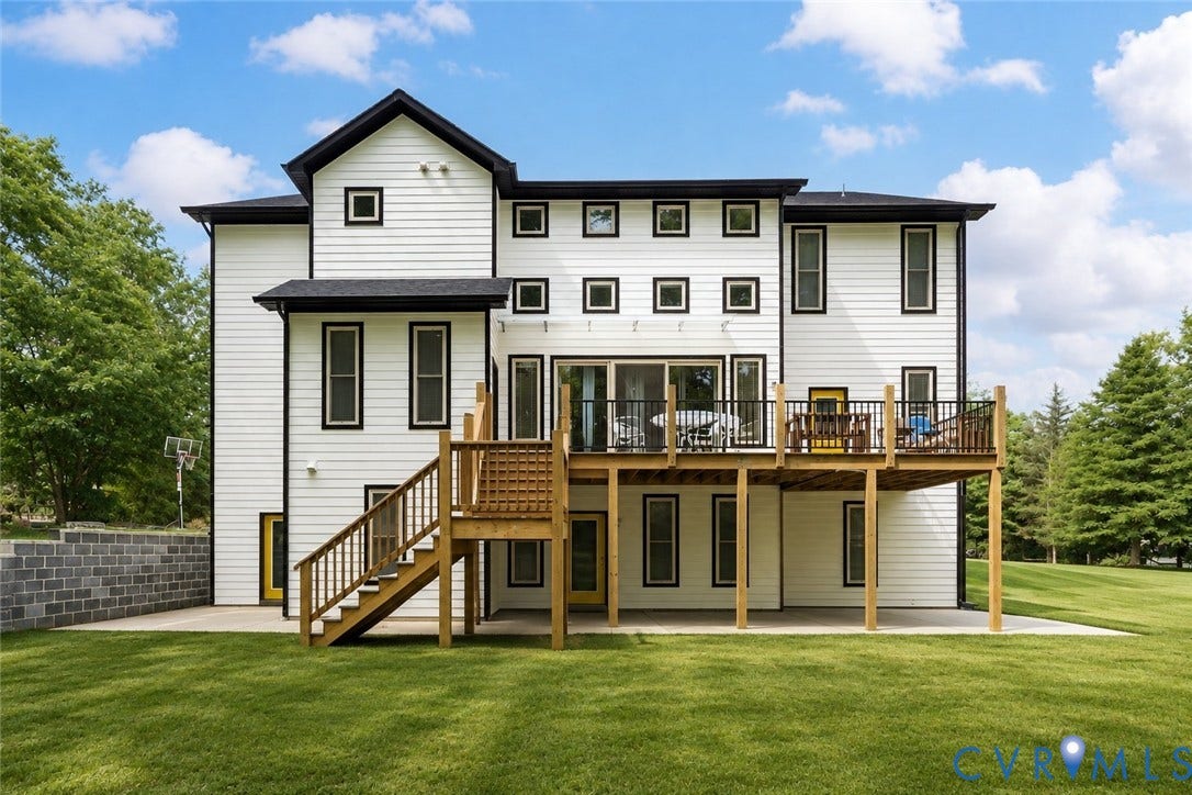 12554 Kain Road, Glen Allen, VA 23059 White exterior siding with black trim windows, multi-level wood deck, ground-level concrete patio, and a tiered block retaining wall