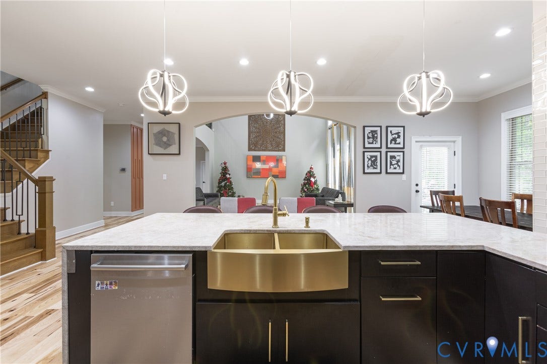 12554 Kain Road, Glen Allen, VA 23059 Kitchen island with a gold-tone apron sink, brushed gold-tone faucet, and stainless steel dishwasher