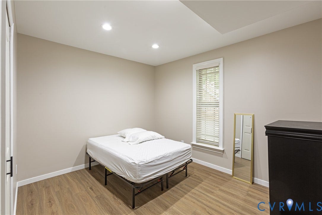 12554 Kain Road, Glen Allen, VA 23059 Bright secondary bedroom featuring recessed ceiling lighting, wood-finish flooring, and a tall window with plantation shutters