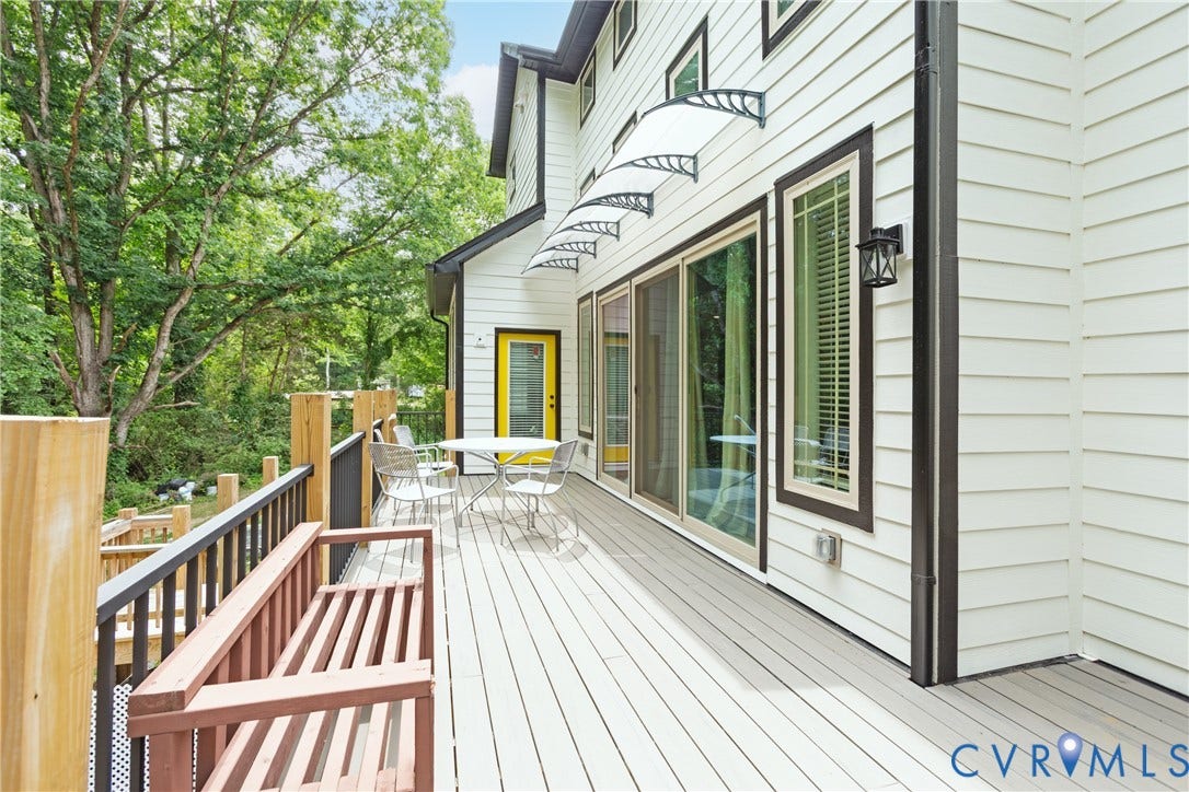 12554 Kain Road, Glen Allen, VA 23059 Expansive composite deck with horizontal wood-finish railings and metal overhead shade structure, overlooking mature landscaping