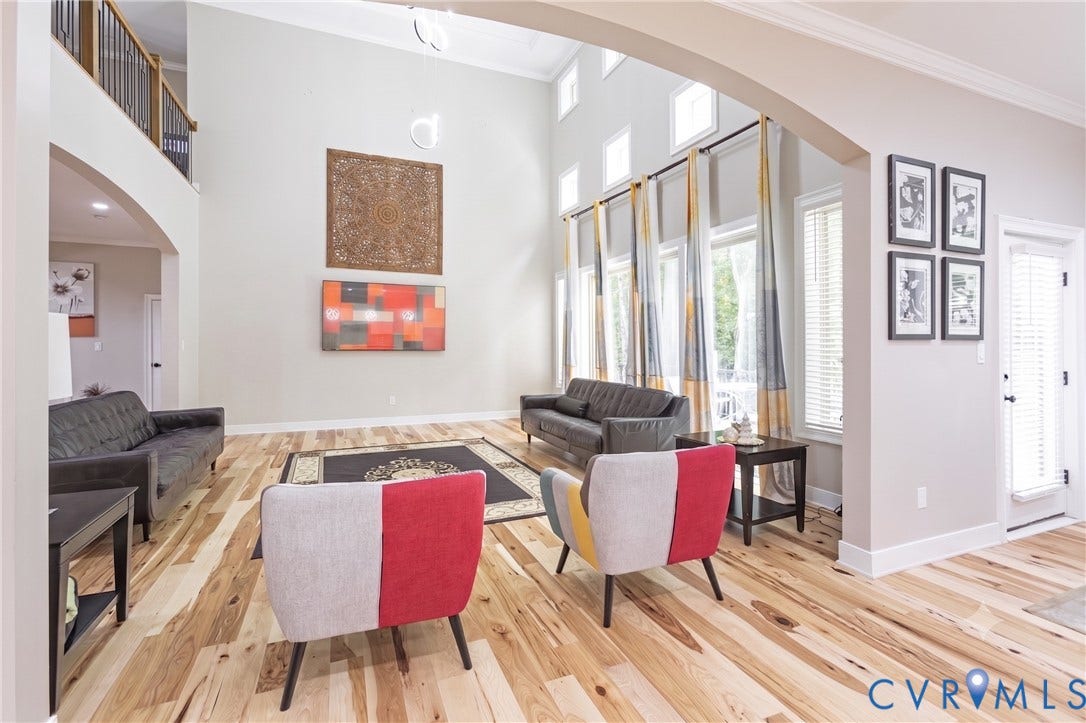 12554 Kain Road, Glen Allen, VA 23059 Soaring ceiling height, expansive windows, light wood-finish flooring, architectural archway, and a second-story interior balcony with an open railing