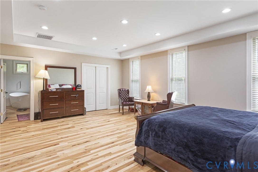 12554 Kain Road, Glen Allen, VA 23059 Recessed lighting, wood-finish flooring, multiple windows with blinds, tray ceiling, and a built-in closet with sliding doors