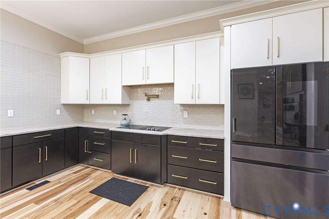 12554 Kain Road, Glen Allen, VA 23059 Two-tone cabinetry with gold-finish hardware, light-toned countertops, tile backsplash, and light wood-finish flooring