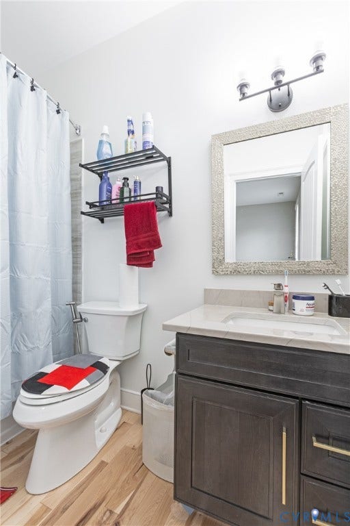 12554 Kain Road, Glen Allen, VA 23059 Modern bathroom featuring a dark wood vanity with brushed nickel hardware, white quartz countertop, and a framed mirror with brushed nickel sconce lighting