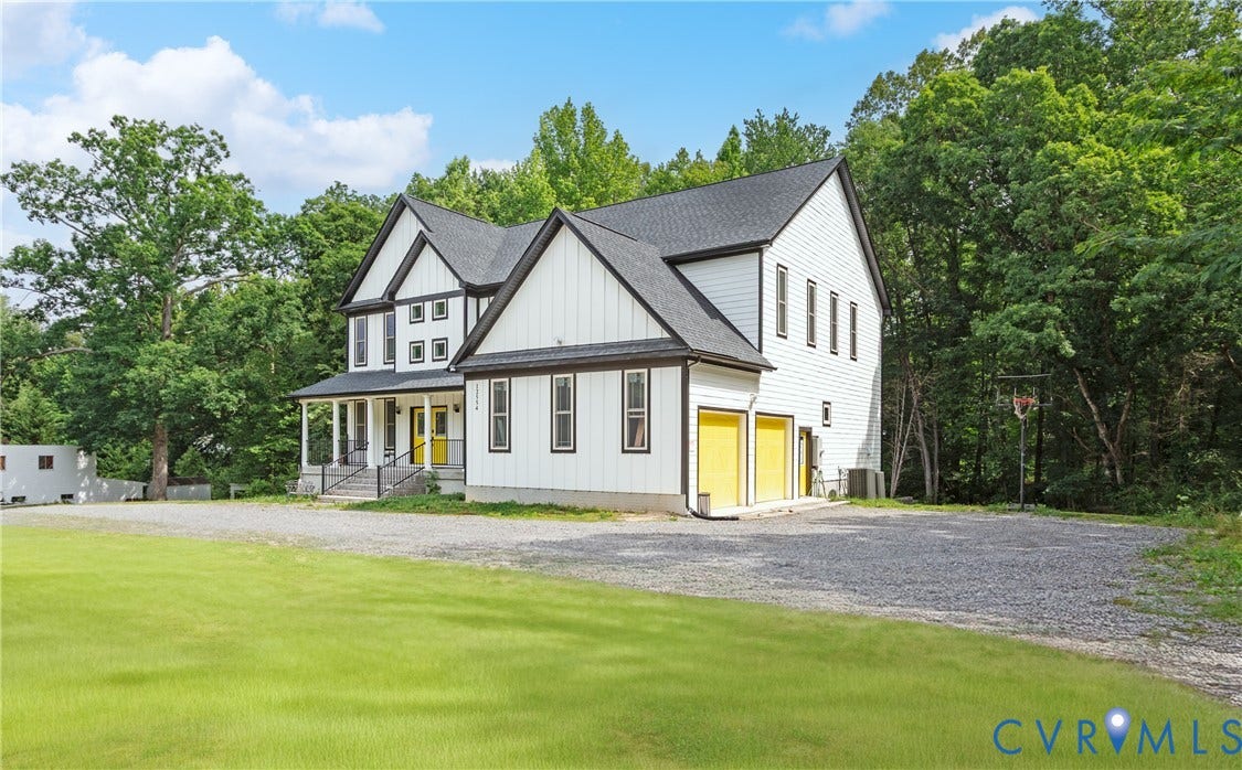 12554 Kain Road, Glen Allen, VA 23059 Contemporary farmhouse exterior with white board and batten siding, dark framed windows, a covered front porch, and a gravel driveway