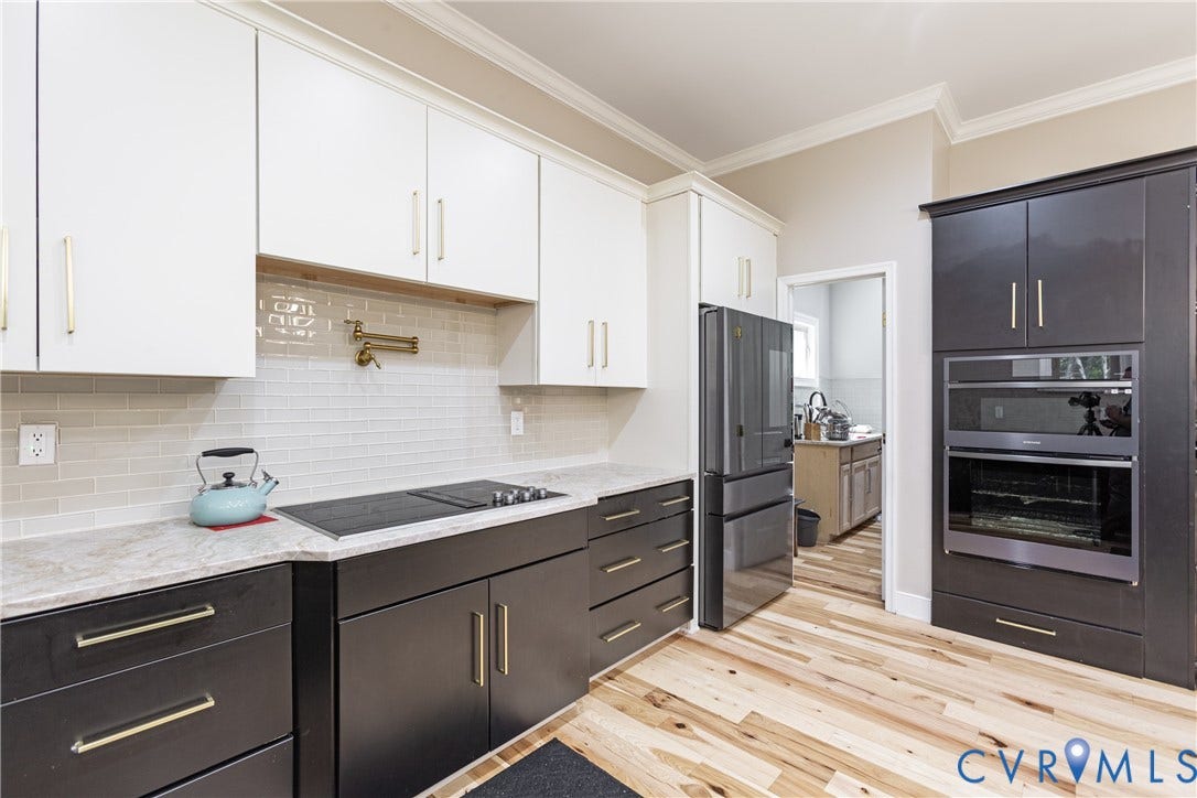 12554 Kain Road, Glen Allen, VA 23059 Modern kitchen with two-tone cabinetry, light wood-finish flooring, a built-in wall oven, and a ceramic cooktop