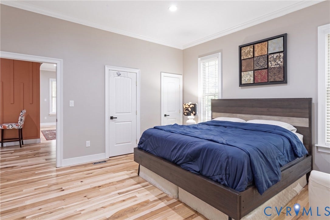 12554 Kain Road, Glen Allen, VA 23059 Light wood-finish flooring, white trim, recessed lighting, crown molding, and multiple windows with blinds