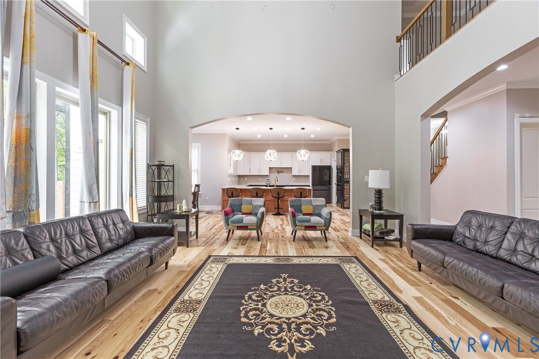 12554 Kain Road, Glen Allen, VA 23059 Spacious living area featuring high ceilings, wood-finish flooring, and an arched entryway
