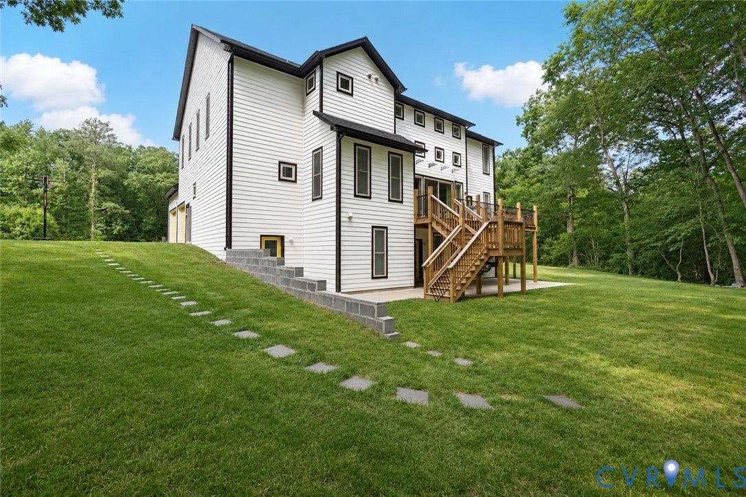 12554 Kain Road, Glen Allen, VA 23059 Modern farmhouse-style residence featuring a multi-level white exterior with black-trimmed windows, composite siding, and a gabled roofline
