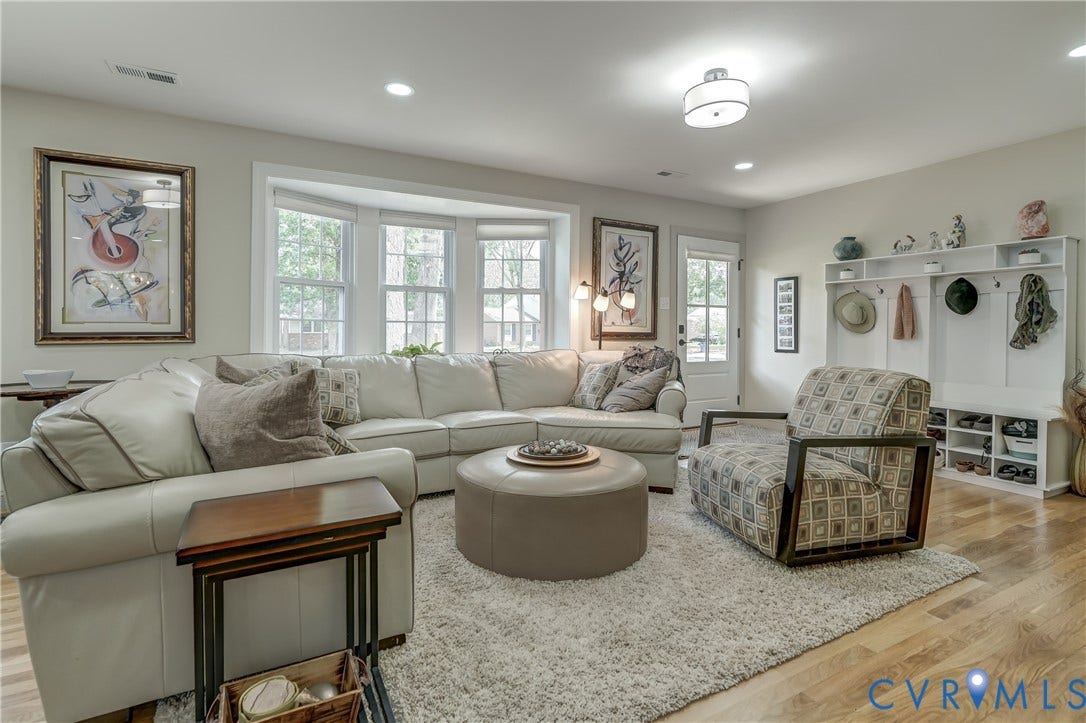 Hardwood flooring, recessed lighting, ceiling-mounted light fixture, bay window with multiple panes, built-in shelving unit with hooks