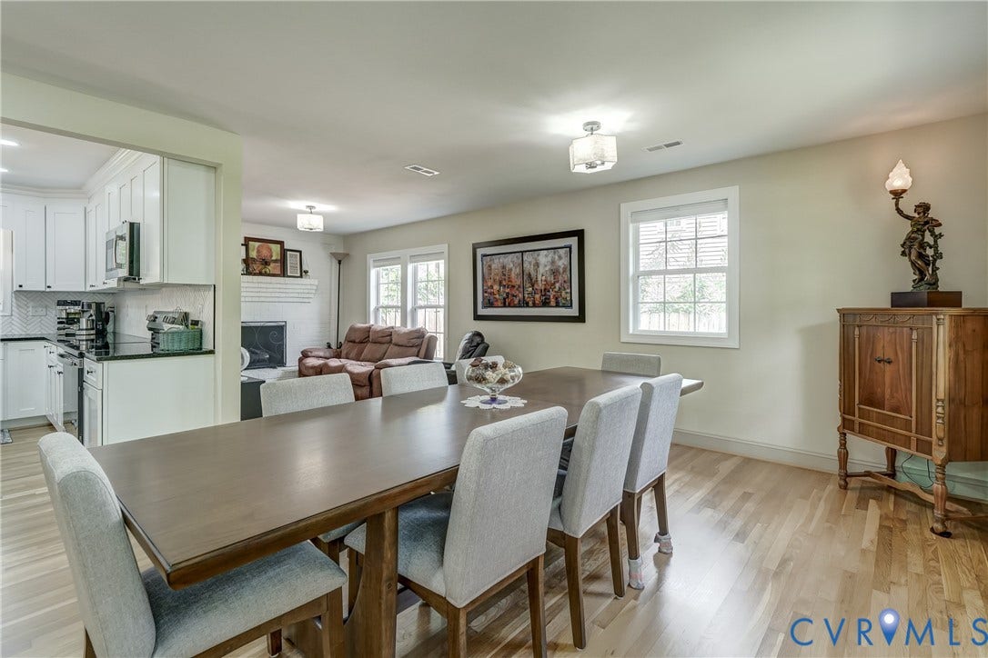 Hardwood flooring, crisp white trim, and a contemporary ceiling light fixture